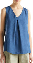 Load image into Gallery viewer, A sleeveless V-neck top in a medium blue linen-like fabric, worn by a model with beige pants against a plain white background.