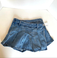 Load image into Gallery viewer, A pair of blue denim pleated mini skirt laid flat on a white surface, with a small white tag attached near the right side.