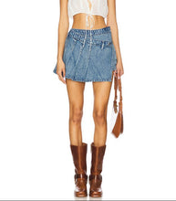 Load image into Gallery viewer, A model wearing a white lace crop top, a blue denim mini skirt, and brown leather cowboy boots, holding a brown leather tassel bag against a plain white background.