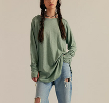 Load image into Gallery viewer, Person wearing a green long-sleeve top and ripped jeans on a beige background
