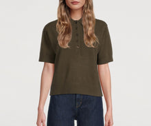 Load image into Gallery viewer, Person wearing an olive green polo shirt and blue jeans on a white background
