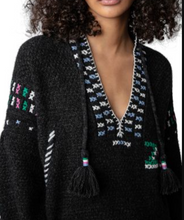 Load image into Gallery viewer, Black cardigan with colorful patterned trim worn by a person