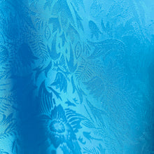 Load image into Gallery viewer, Close-up of blue fabric with floral pattern