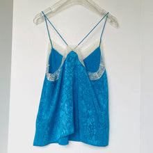 Load image into Gallery viewer, Blue lace camisole on a hanger against a white background