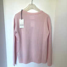 Load image into Gallery viewer, Pink sweater on a hanger with a tag against a white background
