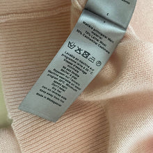 Load image into Gallery viewer, Textile label on a pink fabric background