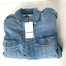 Load image into Gallery viewer, Folded blue denim jacket with a tag on a white background