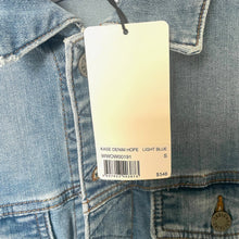 Load image into Gallery viewer, Light blue denim jacket with a tag displaying product details.