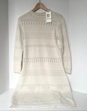 Load image into Gallery viewer, Beige knitted dress on a hanger against a white background