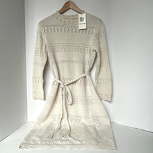 Load image into Gallery viewer, Beige knitted dress with a pattern on a hanger against a white background