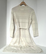 Load image into Gallery viewer, Beige knitted dress on a hanger against a white background