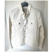 Load image into Gallery viewer, White denim jacket on a hanger against a white background
