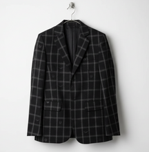 Load image into Gallery viewer, Person wearing a black and gray plaid suit with a pink top underneath on a light gray background