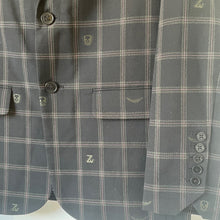Load image into Gallery viewer, Gray plaid jacket with buttons and a brand logo on a white background