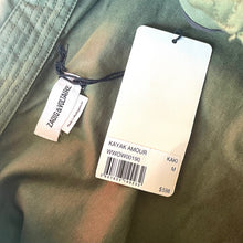 Load image into Gallery viewer, Zadig &amp; Voltaire clothing tag on a green fabric background