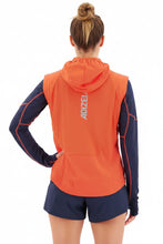 Load image into Gallery viewer, Person wearing an orange and navy running outfit with a visible brand logo on a white background