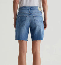 Load image into Gallery viewer, Blue denim shorts worn by a person on a light gray background