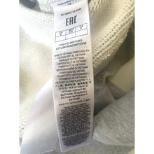 Load image into Gallery viewer, Clothing label with text on a garment