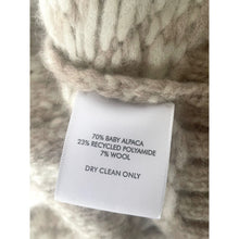 Load image into Gallery viewer, Label on a knitted item with fabric details and care instructions.