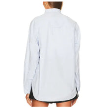 Load image into Gallery viewer, Light blue shirt worn by a person on a white background