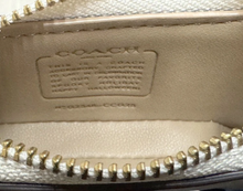 Load image into Gallery viewer, Close-up of a Coach wallet with gold zipper and brand logo.