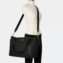 Load image into Gallery viewer, Black handbag on a mannequin with a white background