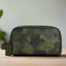 Load image into Gallery viewer, Camouflage-patterned toiletry bag on a white background