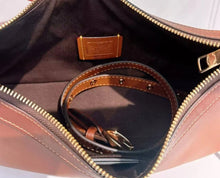 Load image into Gallery viewer, Close-up of a brown leather bag with gold zipper and hardware.