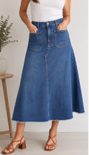 Load image into Gallery viewer, Woman wearing a blue denim skirt with a white background
