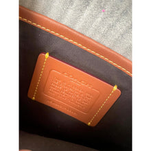 Load image into Gallery viewer, Close-up of a brown leather tag on a product with visible stitching.