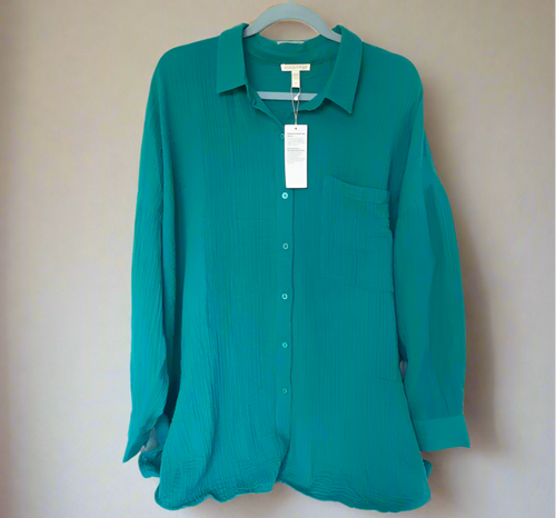 Green shirt on a hanger with a white background