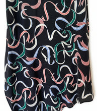 Load image into Gallery viewer, Black fabric with colorful ribbon pattern on a white background