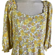 Load image into Gallery viewer, Floral dress with yellow and green pattern on a mannequin against a neutral background