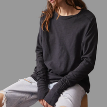 Load image into Gallery viewer, Person wearing a black long-sleeve shirt and light denim shorts against a gray background