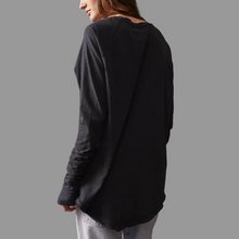 Load image into Gallery viewer, Person wearing a black long-sleeve shirt against a gray background