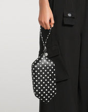 Load image into Gallery viewer, Black polka dot bag held by a person wearing a black outfit.
