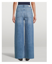 Load image into Gallery viewer, Wide-leg jeans worn by a person on a light gray background