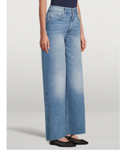 Load image into Gallery viewer, Light blue wide-leg jeans worn by a person on a white background