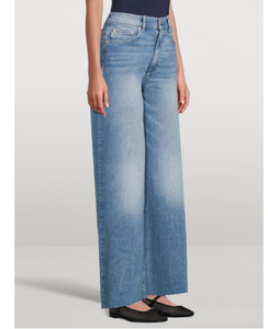 Light blue wide-leg jeans worn by a person on a white background