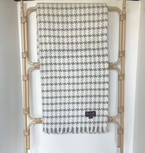 Load image into Gallery viewer, Patterned blanket draped over a decorative rack against a white background