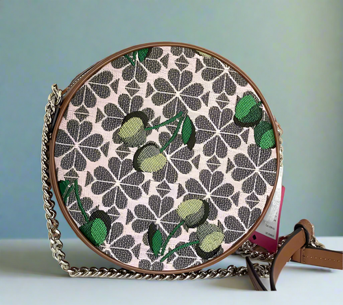 Round handbag with floral pattern and chain strap on a white background