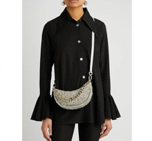 Load image into Gallery viewer, Person wearing a black coat with a textured handbag on a plain background