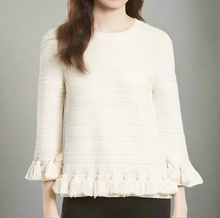 Load image into Gallery viewer, White textured blouse with ruffled hem on a white background