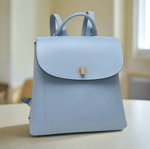 Light blue backpack with a gold clasp on a white background