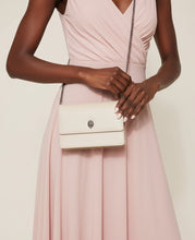 Load image into Gallery viewer, Person wearing a pink dress holding a beige handbag with a chain strap.