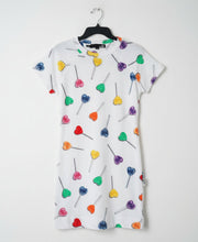 Load image into Gallery viewer, White dress with colorful heart designs on a hanger against a white background