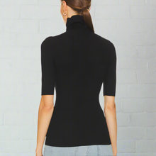Load image into Gallery viewer, Black turtleneck sweater worn by a person on a white background