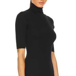 Black turtleneck dress worn by a person on a white background
