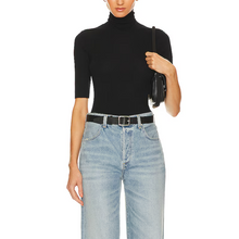 Load image into Gallery viewer, Person wearing a black turtleneck and light blue jeans on a white background