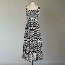 Load image into Gallery viewer, Black and white patterned dress on a mannequin against a white background
